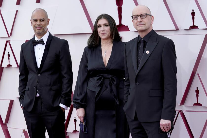 Jesse Collins, from left, Stacey Sher, and Steven Soderbergh arrive at the Oscars on Sunday, April 25, 2021, at Union Station in Los Angeles. (AP Photo/Chris Pizzello, Pool)