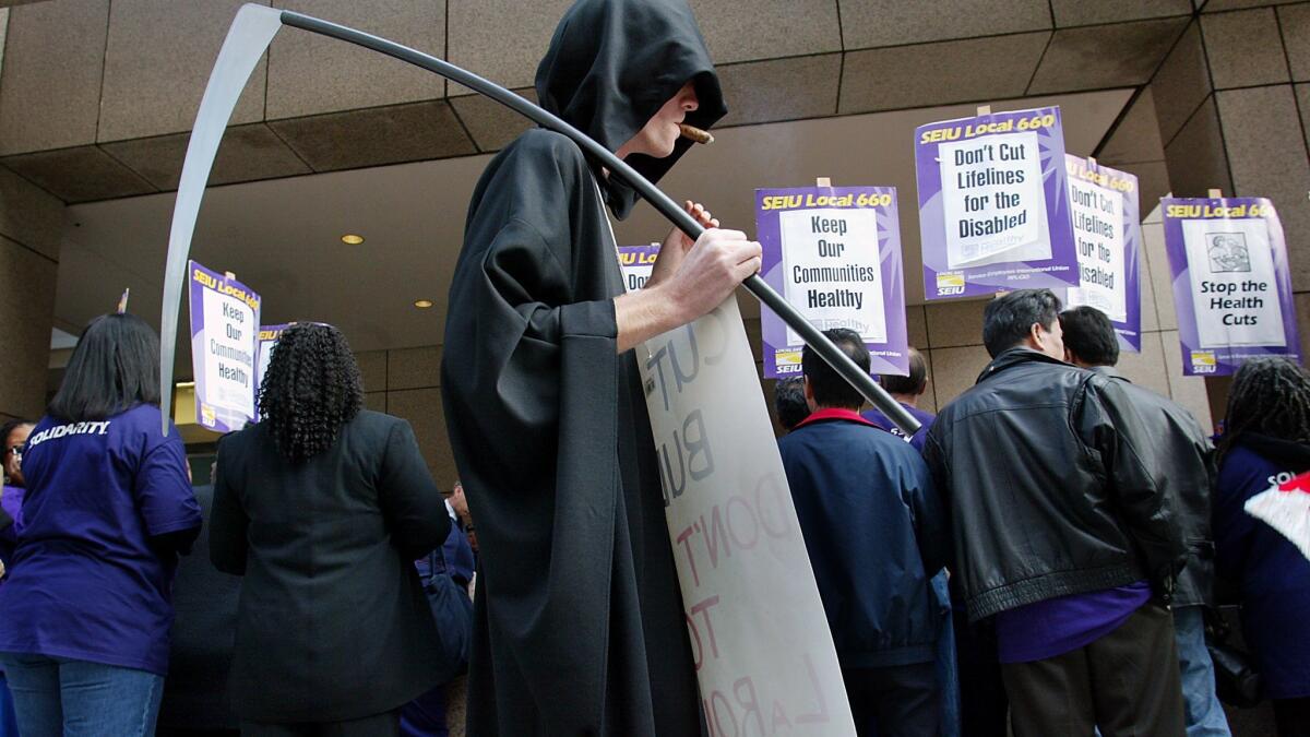 A Lyndon LaRouche supporter dressed as the Grim Reaper at a demonstration outside the Ronald Reagan Building in Los Angeles in 2002.