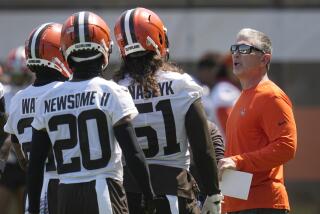 Browns defensive coordinator Jim Schwartz talks with his defenders.