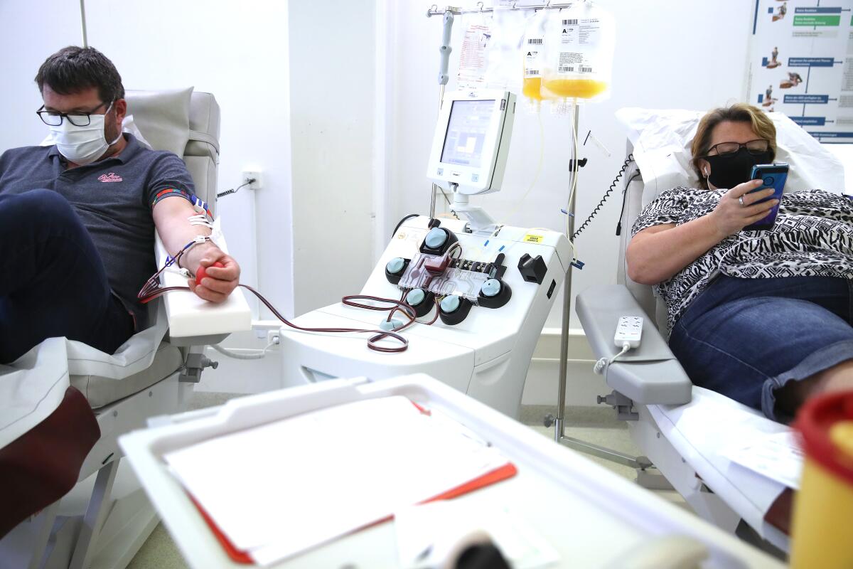 Two people who have recovered from COVID-19 donate blood plasma for researchers to study.