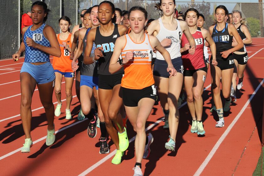 Huntington Beach's Mackenzie McRae, center, and Corona del Mar's Melisse Djomby Enyawe, left, in a track and field meet.