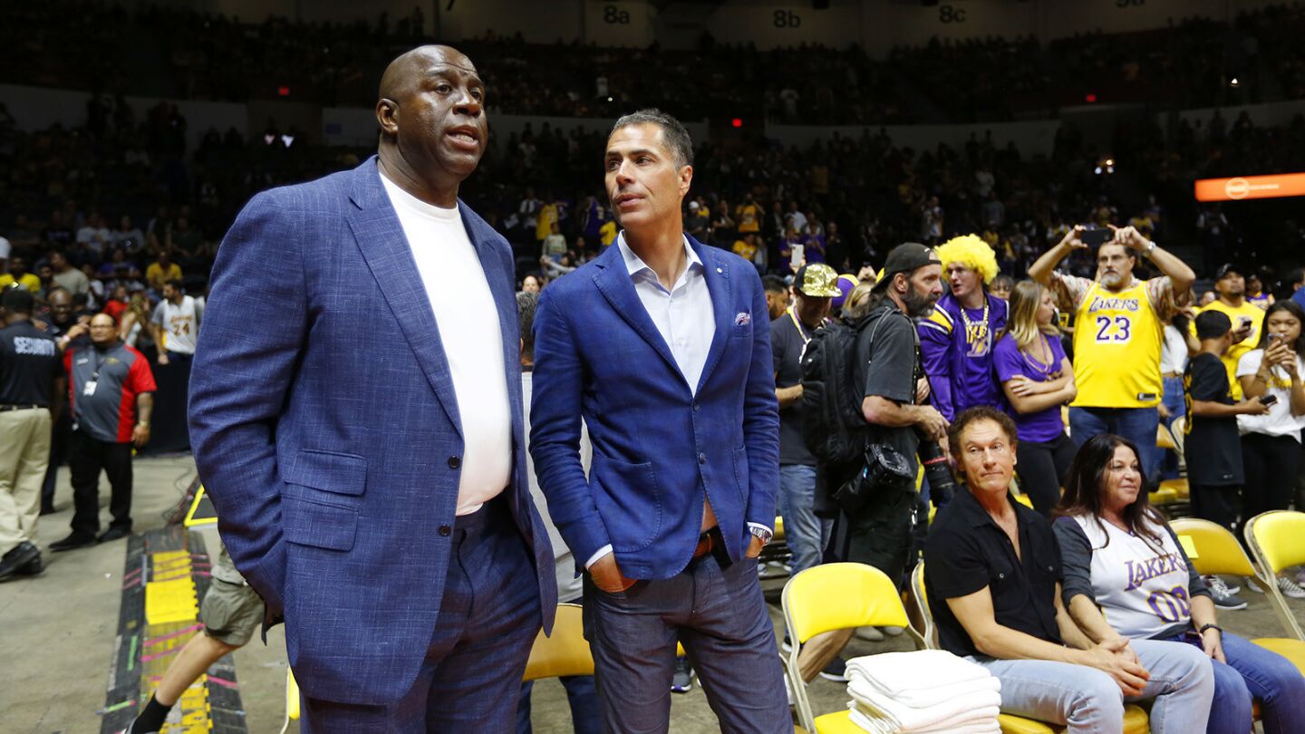 Los Angeles Lakers President of Basketball Operations Magic Johnson and General Mangager Rob Pelinka looks on before a game against the Denver Nuggets in San Diego on Sunday, September 30, 2018. (Photo by K.C. Alfred/San Diego Union-Tribune)