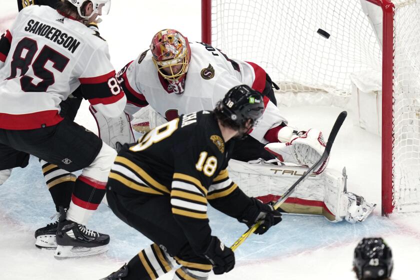 Boston Bruins center Pavel Zacha (18) backhands a shot past Ottawa Senators goaltender Anton Forsberg (31) for a goal during the third period of an NHL hockey game Tuesday, April 16, 2024, in Boston. (AP Photo/Charles Krupa)