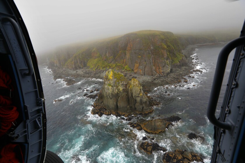 Rocky coastal terrain seen from a helicopter 