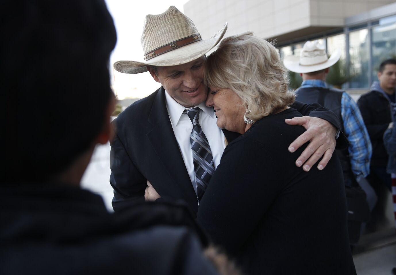 Ammon Bundy, left, hugs is aunt Lillie Spencer outside of a federal courthouse in Las Vegas after U.S. District Judge Gloria Navarro declared a mistrial in the case against Cliven Bundy, his sons Ryan and Ammon Bundy.