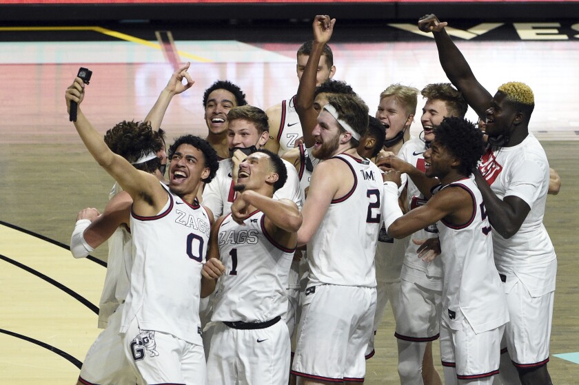 Gonzaga players celebrate after defeating BYU in an NCAA college basketball game for the West Coast Conference men's tournament championship Tuesday, March 9, 2021, in Las Vegas. (AP Photo/David Becker)