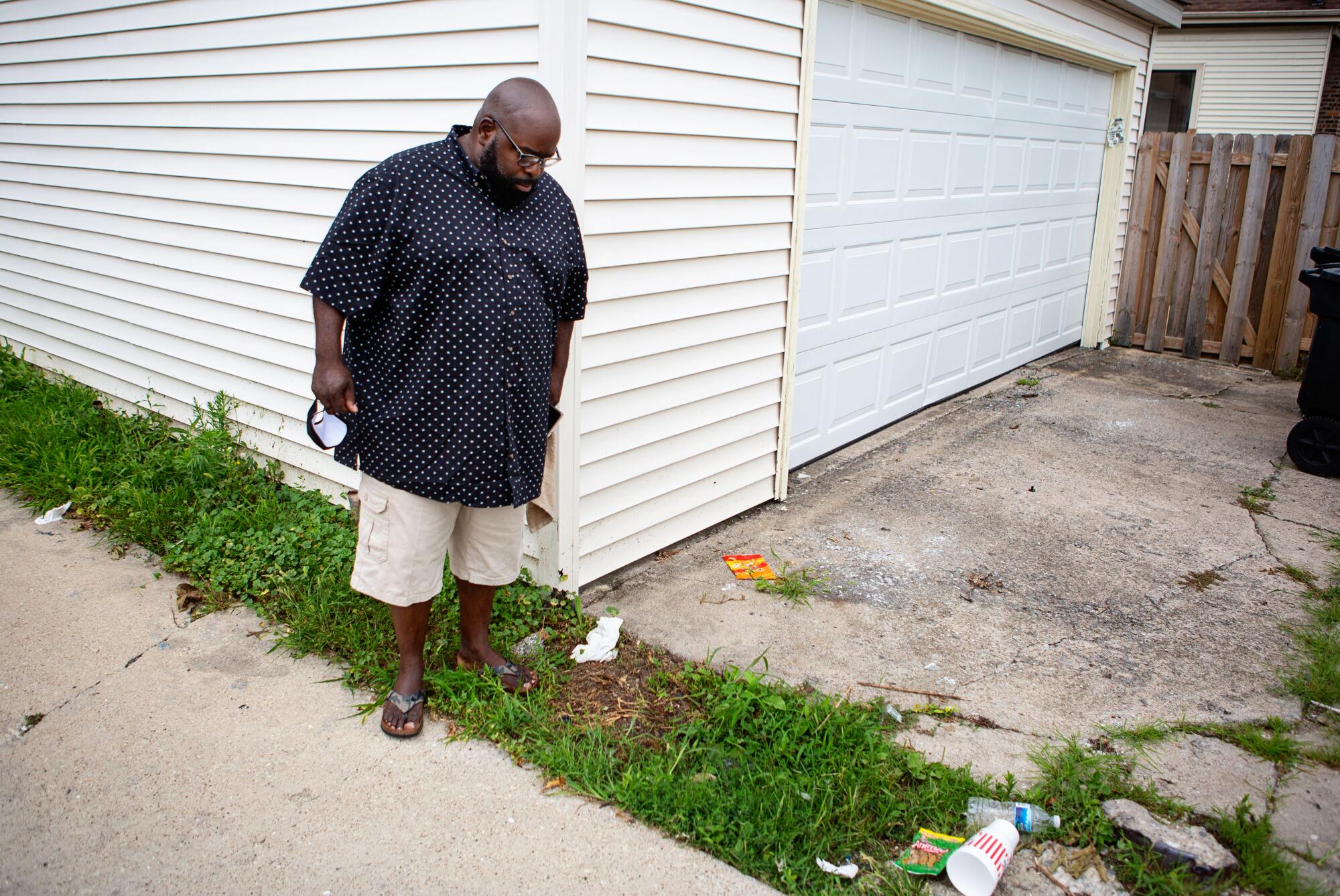 Donovan Price looks down at the spot where 9-year-old Tyshawn Lee was lured to an alley and killed.