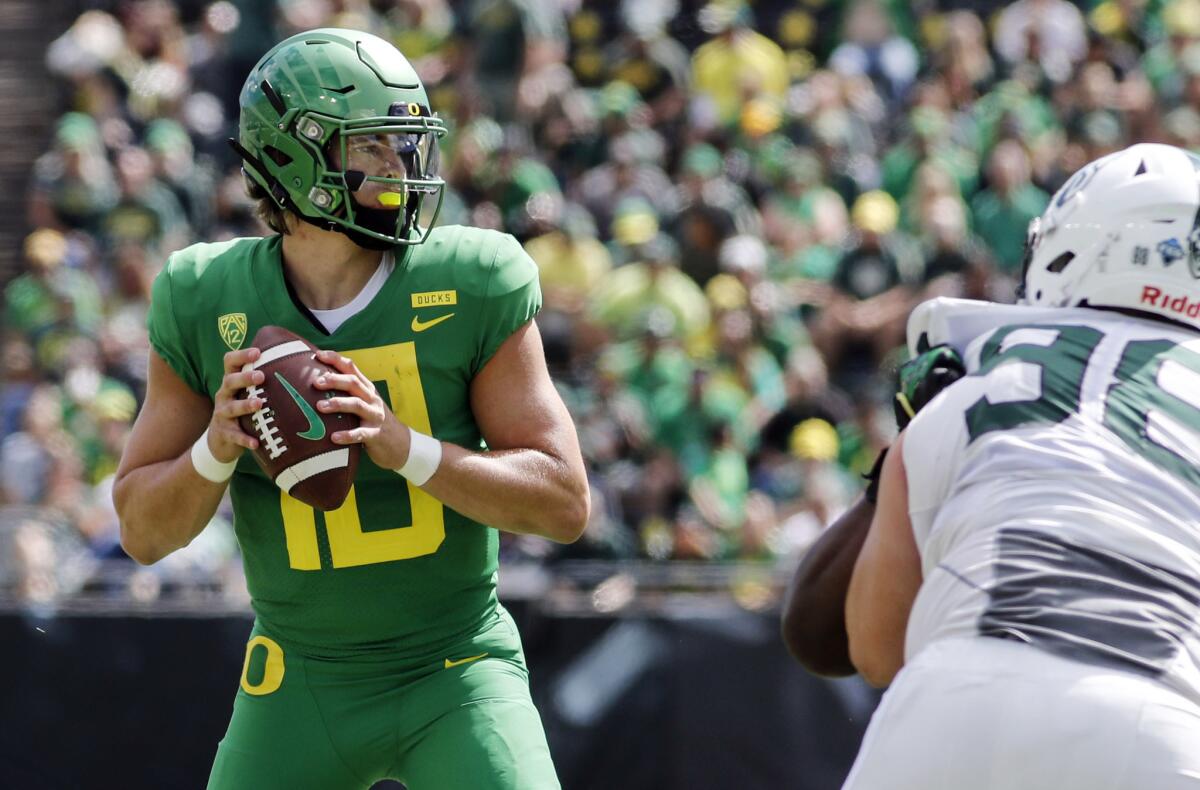 Oregon quarterback Justin Herbert looks for a receiver.