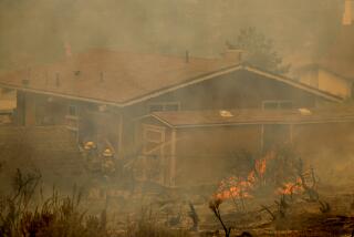 Wrightwood, CA - September 11: San Bernardino County firefighters work to save a home in Wrightwood as they battle the Bridge Fire amid high temperatures in Wrightwood Wednesday, Sept. 11, 2024. (Allen J. Schaben / Los Angeles Times)