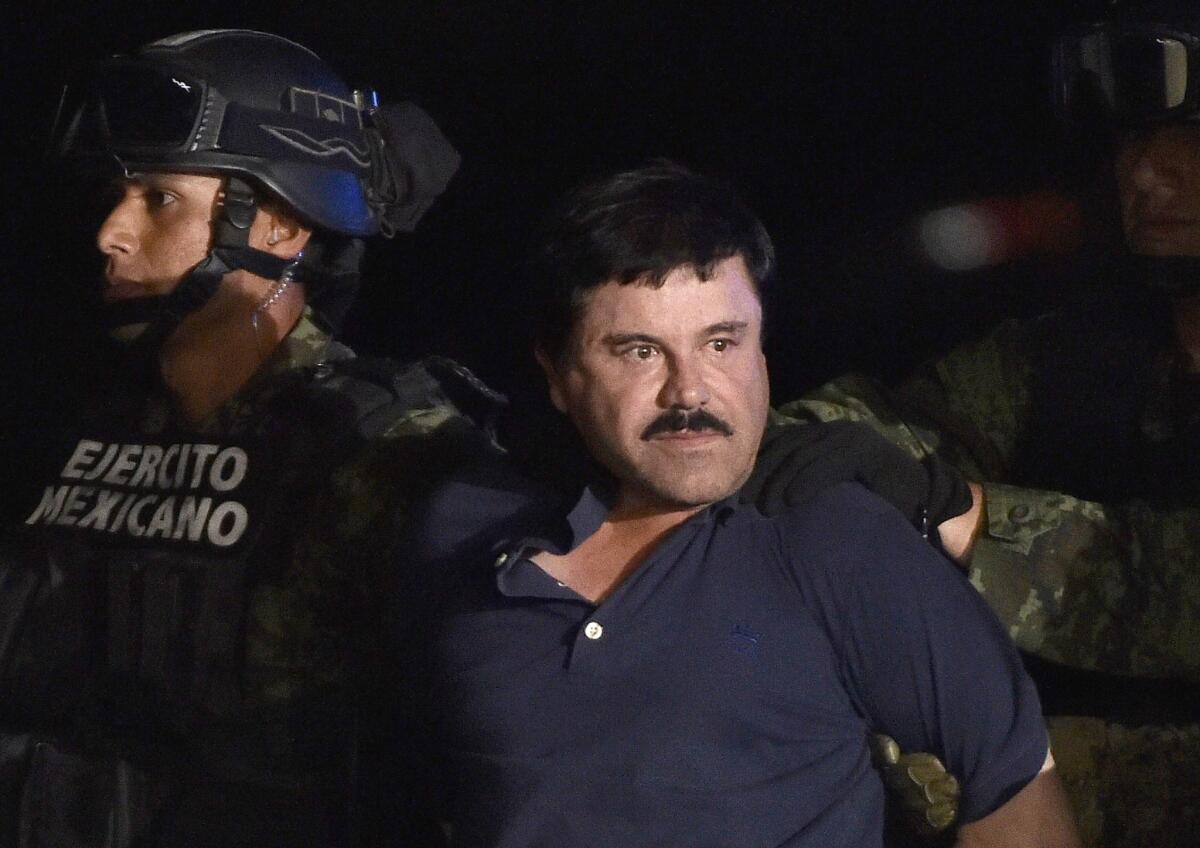 Drug kingpin Joaquin "El Chapo" Guzman is escorted to a helicopter at Mexico City's airport on Jan. 8, 2016 following his recapture during an intense military operation in Los Mochis, in Sinaloa, Mexico.