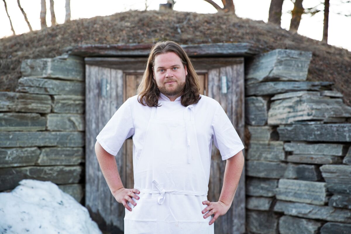 Chef Magnus Nilsson in front of his famous root cellar at Fäviken.