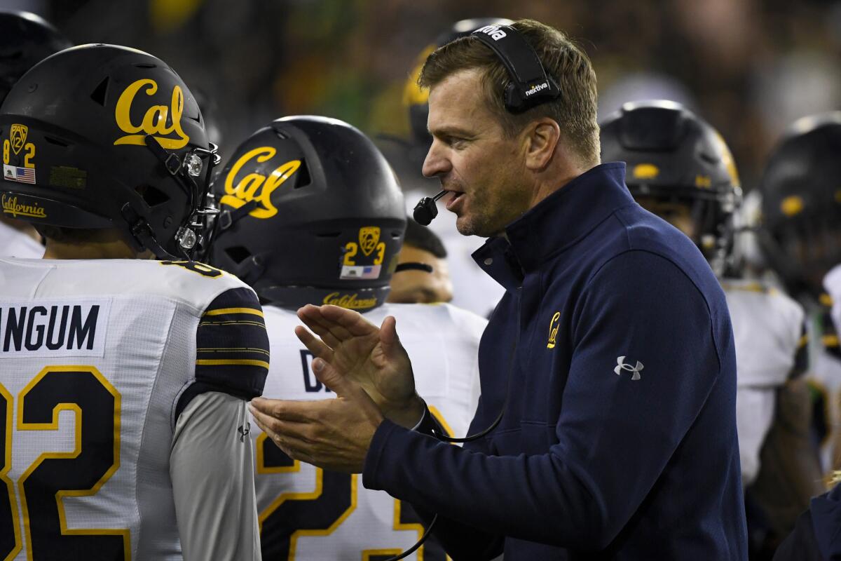 FILE - California head coach Justin Wilcox encourages his players during the fourth quarter of an NCAA college football game on Oct. 15, 2021, in Eugene, Ore. Cal ranks last in the conference in scoring and sixth worst in the Power 5 at 23.2 points per game since the school replaced the offensive-minded Sonny Dykes with the defensive-oriented Wilcox in 2017. (AP Photo/Andy Nelson, File)