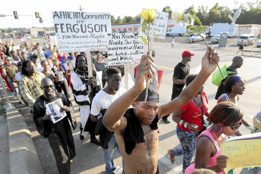 Protesters march in Ferguson, Mo., over the police slaying of Michael Brown. Officials pleaded with people to stay home Tuesday night, to no avail.