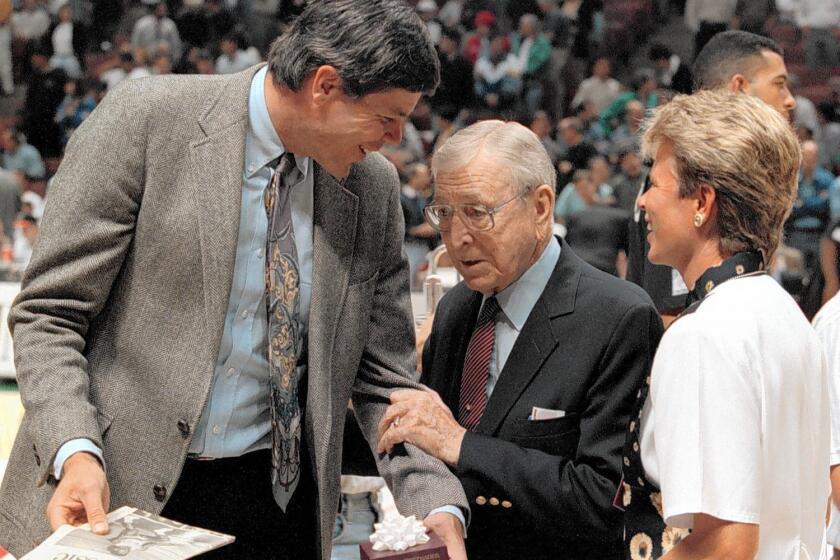 Former UCLA star basketball player Dave Meyers, left, with former coach John Wooden, in 1995.