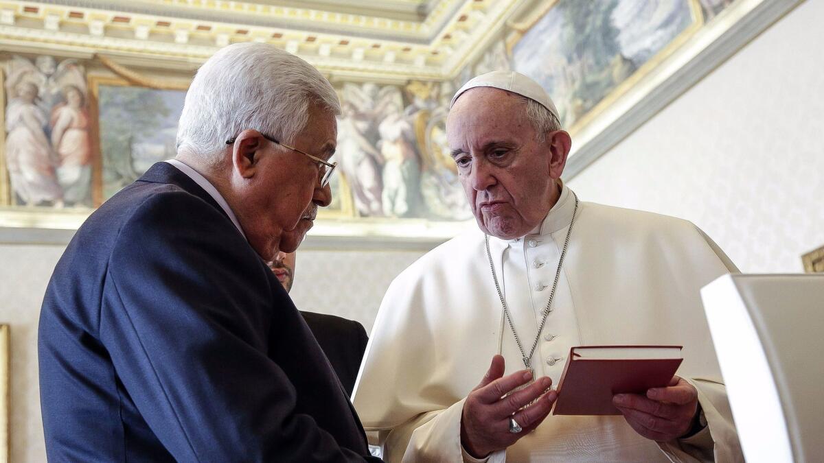 Palestinian President Mahmoud Abbas and Pope Francis exchange gifts at the Vatican.