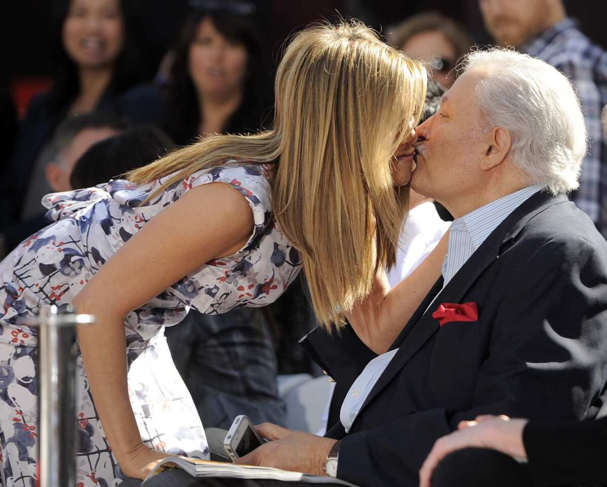 Jennifer Aniston gives her dad, actor John Aniston, a kiss.