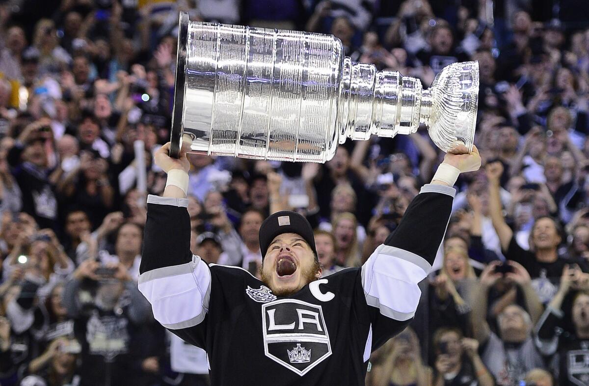 Dustin Brown lifts the Stanley Cup after the Kings' 6-1 victory over the New Jersey Devils on June 11, 2012.