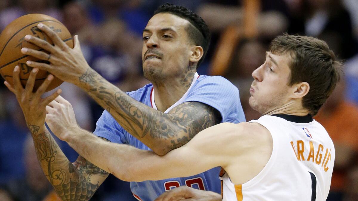 Phoenix Suns guard Goran Dragic, right, tries to steal the ball from Matt Barnes during the Clippers' 120-100 win Sunday.