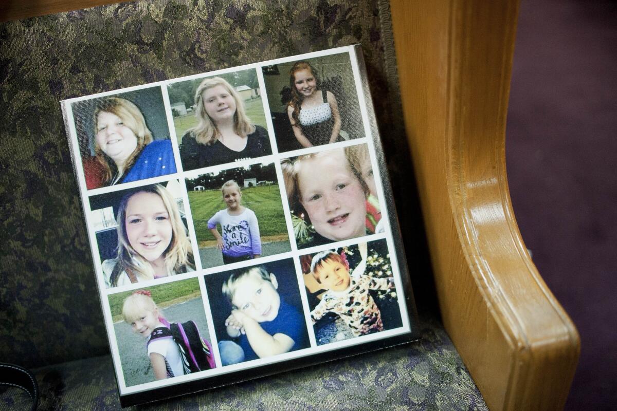 A composite picture of the Watson family is displayed during a service held for them at Calvary Baptist Church in Central City, Ky. Nine members of the Watson family were killed Thursday morning in a house fire.