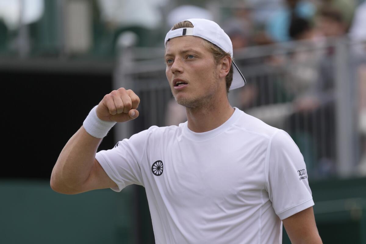 Tim van Rijthoven celebrates winning the first set against Nikoloz Basilashvili in a Wimbledon match July 1, 2022. 