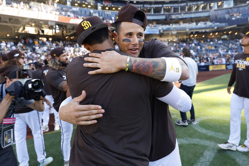 SAN DIEGO, CA - OCTOBER 2: San Diego Padres' Manny Machado and Juan Soto celebrate after the team clinched a wildcard playoff spot during against the Chicago White Sox at Petco Park on Sunday, October 2, 2022 in San Diego, CA. (K.C. Alfred / The San Diego Union-Tribune)