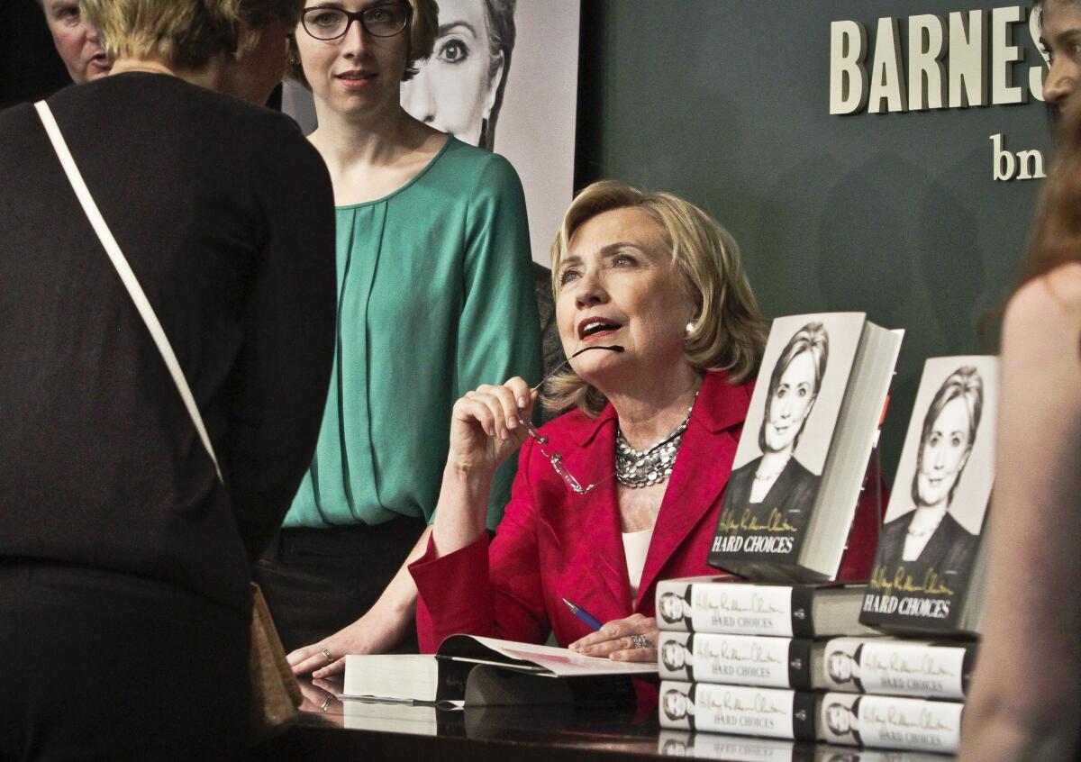 Hillary Clinton signs copies of her memoir "Hard Choices" in June 2014. She's sent copies of the book to the Republican presidential candidates.