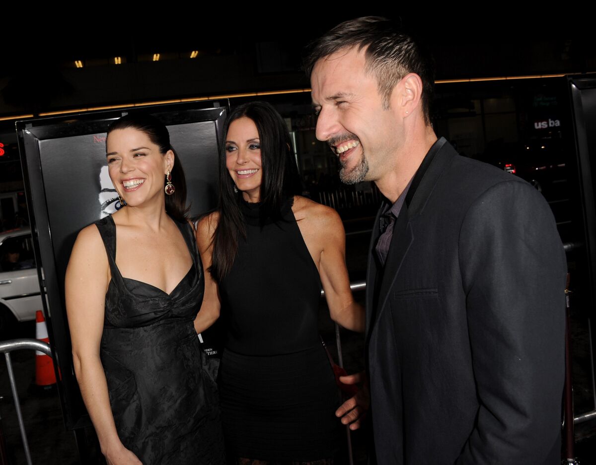 Actors Neve Campbell, Courteney Cox and David Arquette arrive at the premiere of "Scream 4" in 2011.