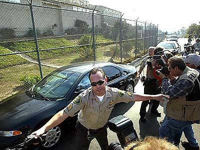 Santa Barbara Sherriff attempts to keep back crowds as motorcade with Michael Jackson arrives at Santa Barbara County Jail.