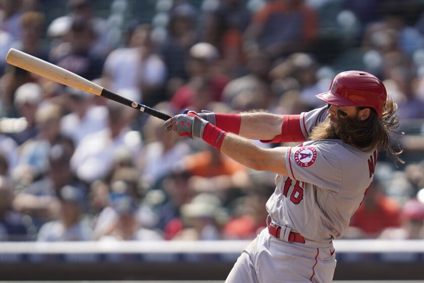 Los Angeles Angels' Brandon Marsh hits a two-run triple against the Detroit Tigers in the sixth inning of a baseball game in Detroit, Thursday, Aug. 19, 2021. (AP Photo/Paul Sancya)