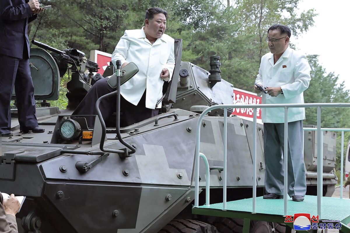 North Korean leader Kim Jong Un riding on an armored vehicle