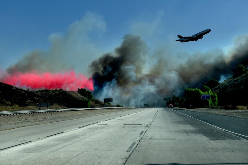 SIMI VALLEY, CALIFORNIA OCTOBER 30, 2019-An air tanker drops phos-chek near the 23 Freeway as firefighters make a stand and prevent the Easy Firefrom burning into Moorepark Wednesday. (Wally Skalij/Los Angerles Times)