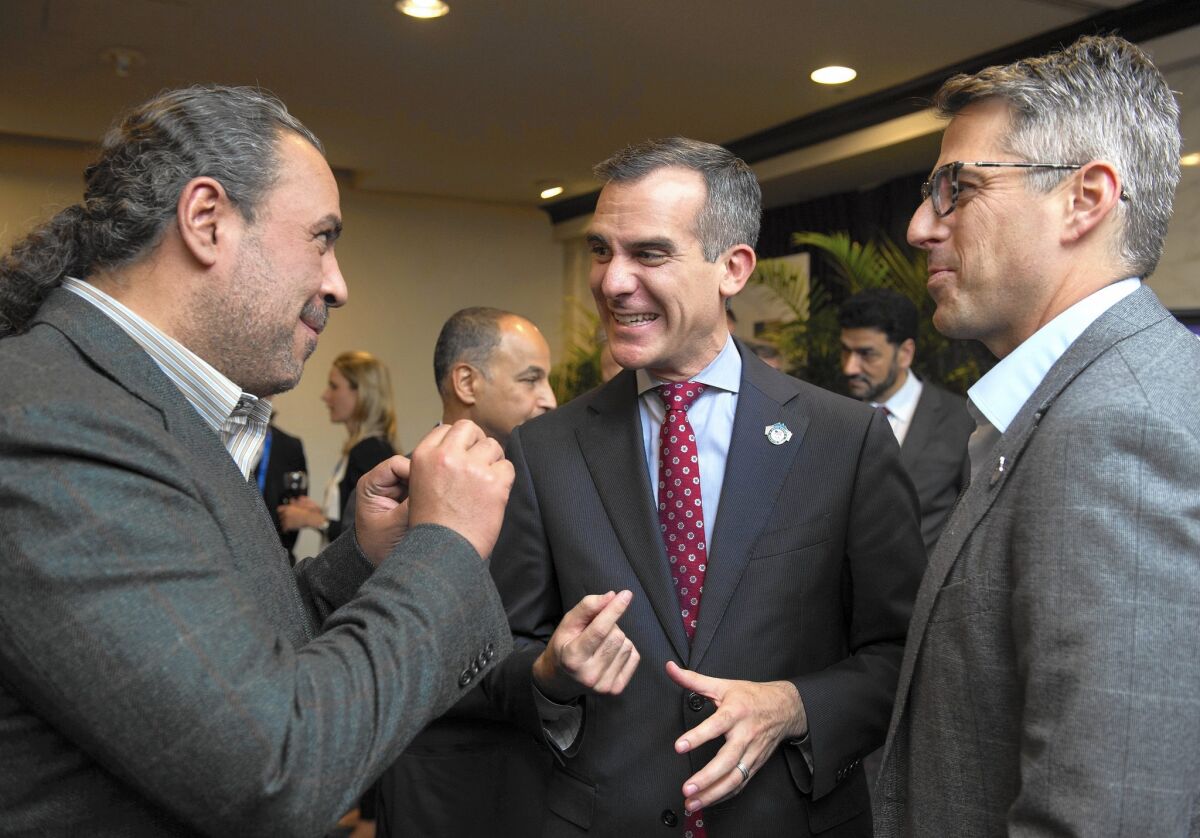 ANOC President Sheikh Ahmad Al-Fahad Al-Sabah, left, speaks with Casey Wasserman, LA 2024 Chairman, right, and Los Angeles Mayor Mayor Eric Garcetti, at the reception before the XX ANOC General Assembly 2015 on Oct. 27 in Washington, DC.