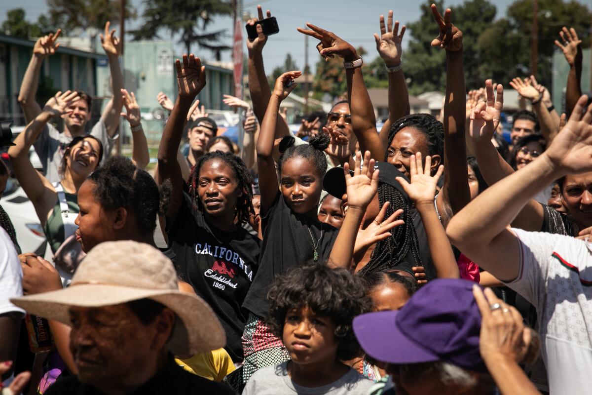 Children raise their hands.