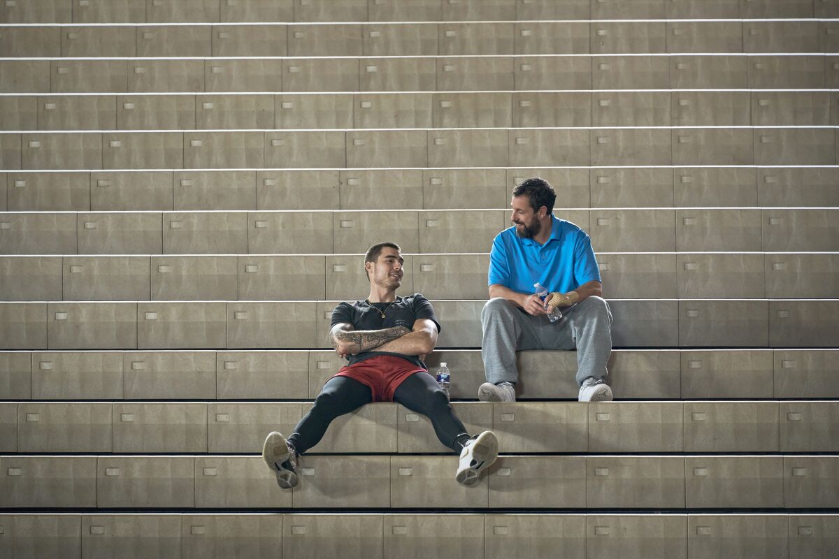 Two men in conversation on bleachers