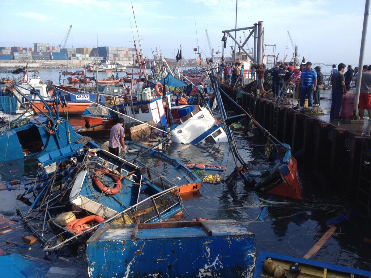 Sunken fishing boats are seen at Riquelme Cove in Iquique, Chile, after a magnitude 8.2 hit off the coast.