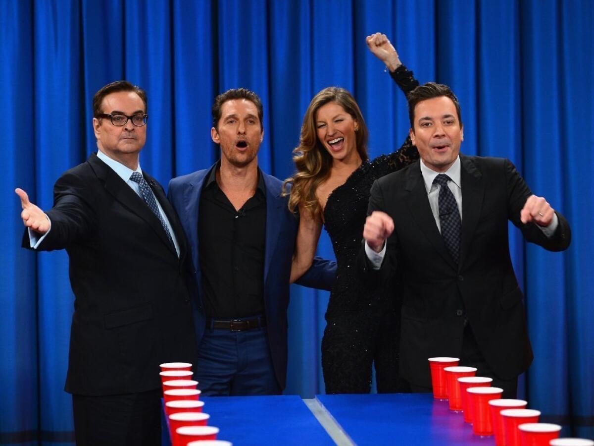 Jimmy Fallon, right, shown with comedian Steve Higgins, left, actor Matthew McConaughey and model Gisele Bundchen on the set of "Late Night," is taking over NBC's "Tonight Show" in February.