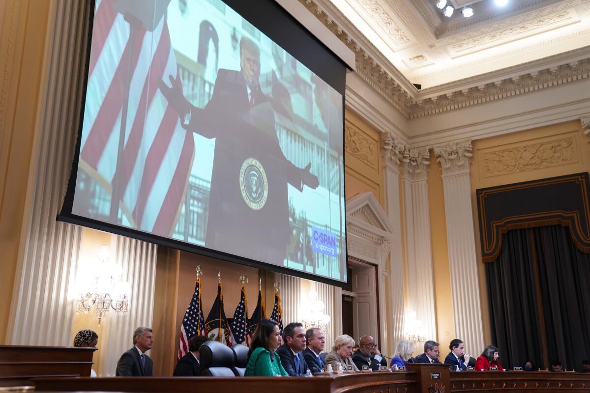 The House select committee investigating the Jan. 6 Capitol riot listens to a video.