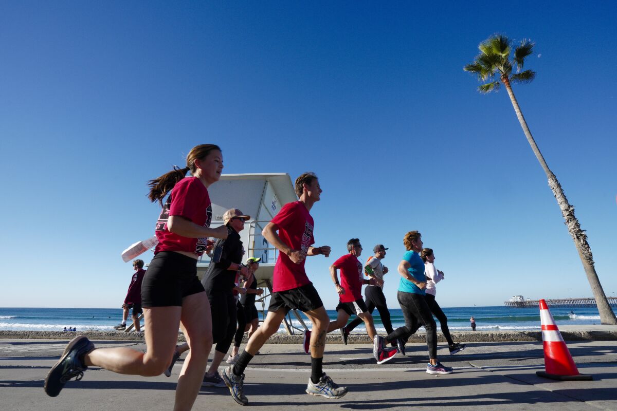 Runners come down the final stretch in the 5K Turkey Trot towards the finish line just south of Oceanside Pier on The Strand.