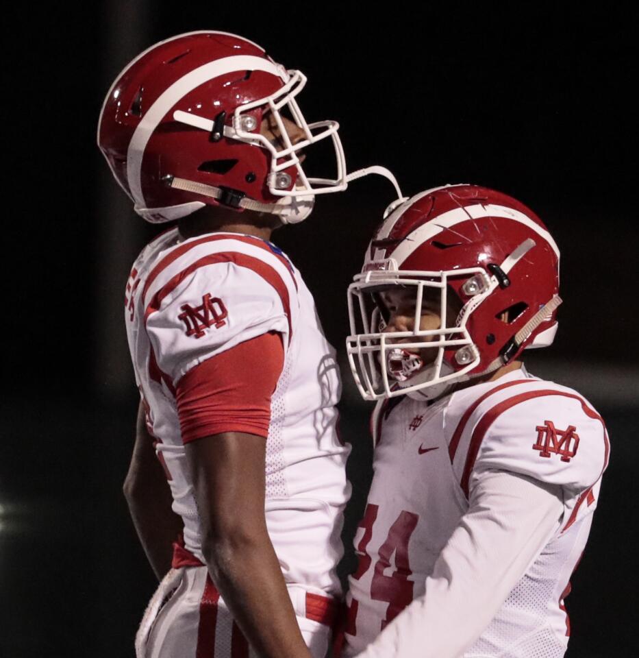 Mater Dei wide receiver Kody Epps, left, celebrates with teammate Quincy Craig