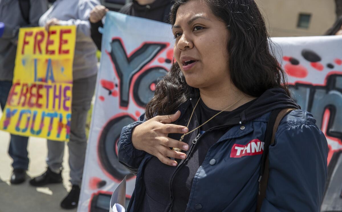 Erica Montelongo, 26, a member of the Youth Justice Coalition, calls for the release of youths from juvenile detention because of the COVID-19 crisis during a news conference outside the Eastlake Juvenile Court in Los Angeles.