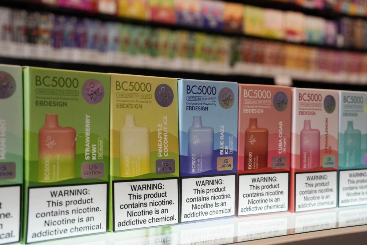 Varieties of disposable flavored electronic cigarette devices at a store.