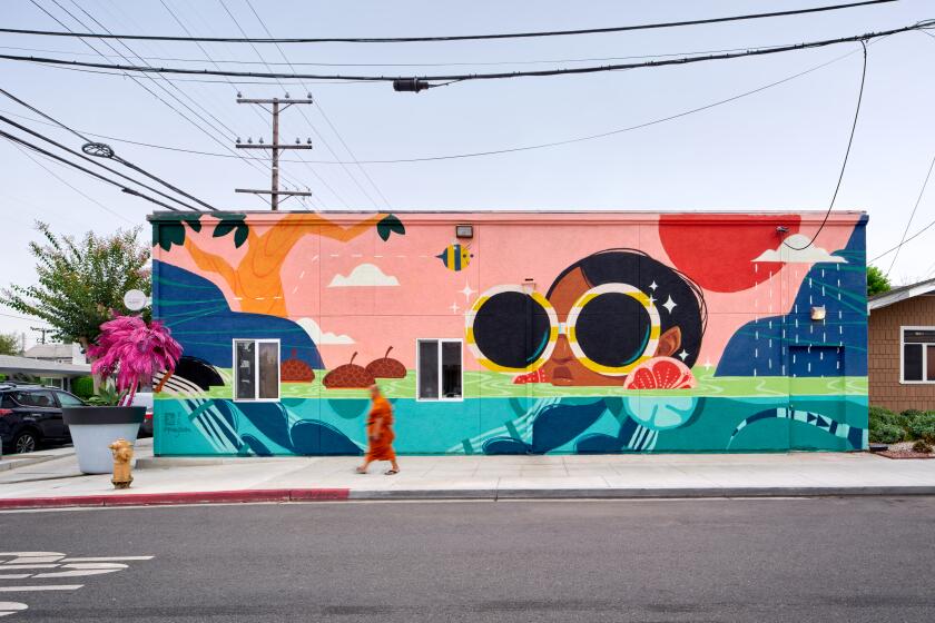 A building is painted as a fanciful landscape, with two circular windows serving as lens for one character's sunglasses.