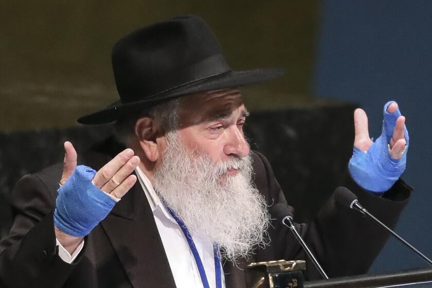 FILE - In this June 26, 2019, file photo, Rabbi Yisroel Goldstein, senior rabbi of Chabad of Poway synagogue in San Diego, Calif., addresses the United Nations General Assembly's meeting on combating antisemitism and other forms of racism and hate in the digital age at U.N. headquarters. The rabbi who had part of his hand shot off in a deadly attack at his Southern California synagogue pleaded guilty Tuesday, July 14, 2020, to federal charges of tax and wire fraud, according to a newspaper report. Rabbi Goldstein, 58, acknowledged his role in a scheme in which donors made large contributions to Chabad of Poway but then secretly got most of the money back, the San Diego Union-Tribune reported. (AP Photo/Bebeto Matthews, File)