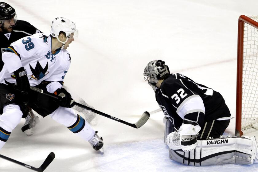 Sharks center Logan Couture (39) scores against Kings goalie Jonathan Quick in the first period on Jan. 21 in San Jose.
