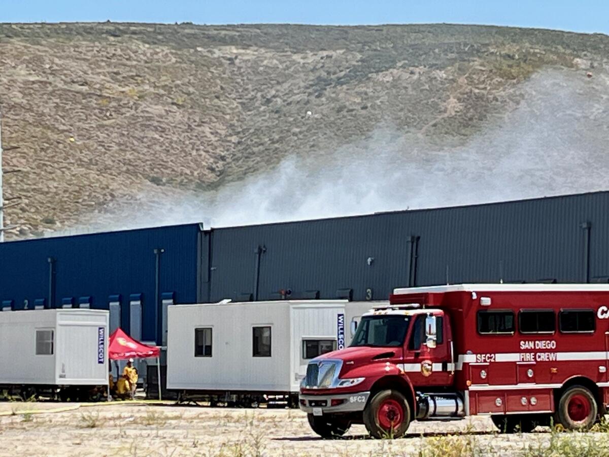 A battery fire continued to smolder at the Gateway Energy Storage facility in Otay Mesa on Tuesday.