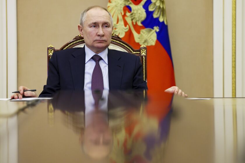 FILE - Russian President Vladimir Putin attends a ceremony to open new pharmaceutical production facilities in the Kaliningrad Region, Mordovia and St Petersburg via videoconference in Moscow, Russia, Thursday, March 30, 2023. An international arrest warrant for President Vladimir Putin raises the prospect of justice for the man whose country invaded Ukraine but complicates efforts to end that war in peace talks. (Gavriil Grigorov/Sputnik, Kremlin Pool Photo via AP, File)