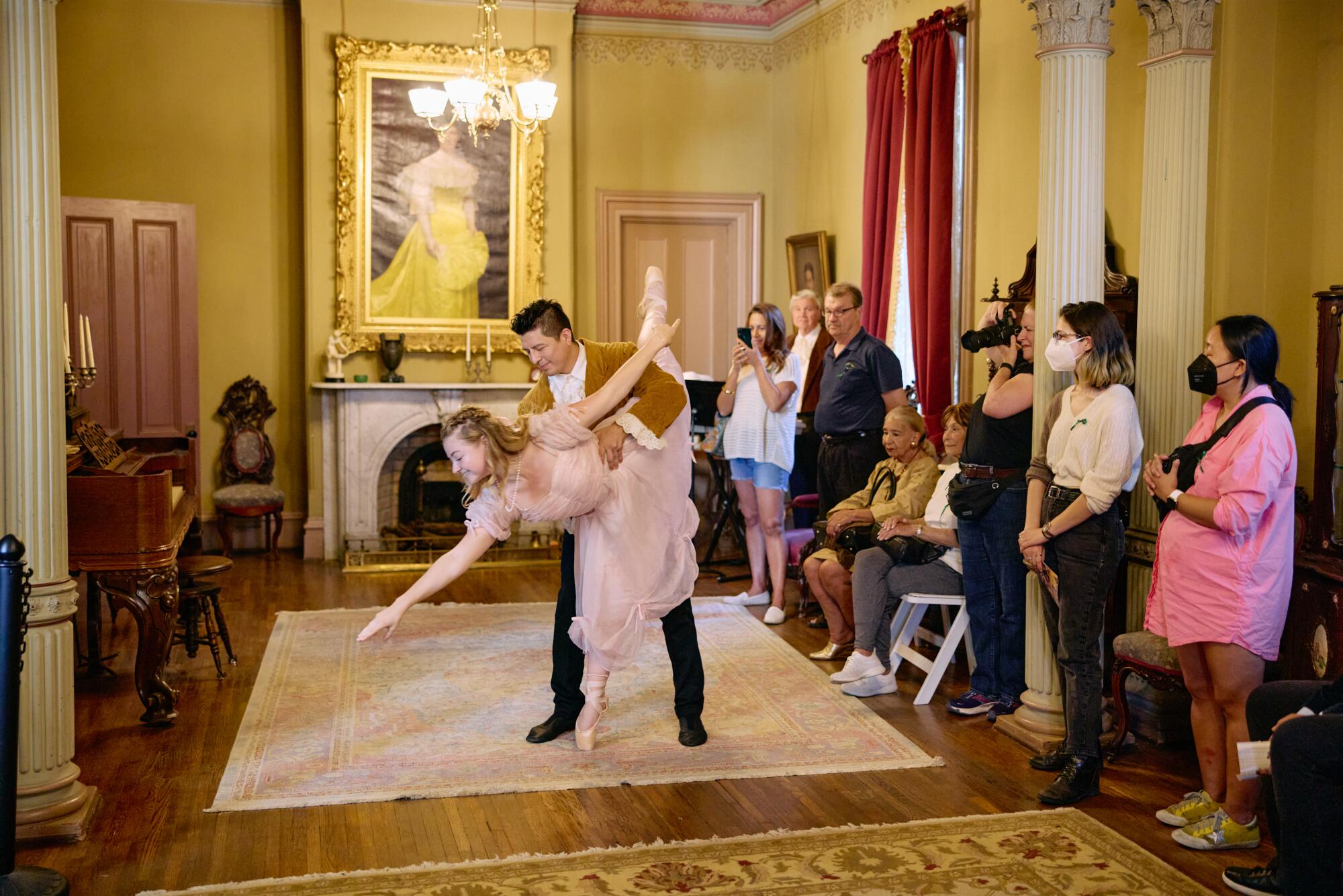 A couple perform a ballet before an audience at L.A.'s Heritage Square Museum