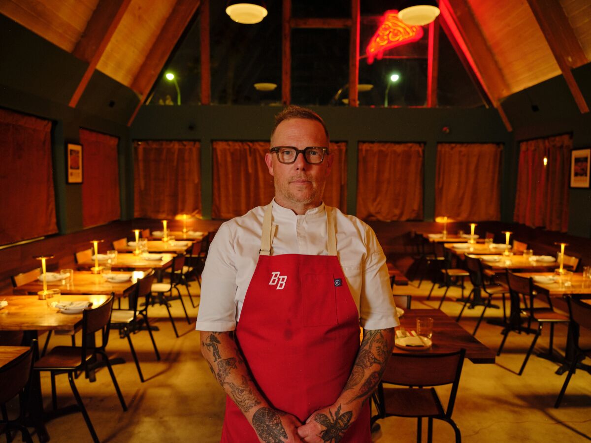 Chef Jason Neroni stands in the A-frame dining room of his new restaurant.