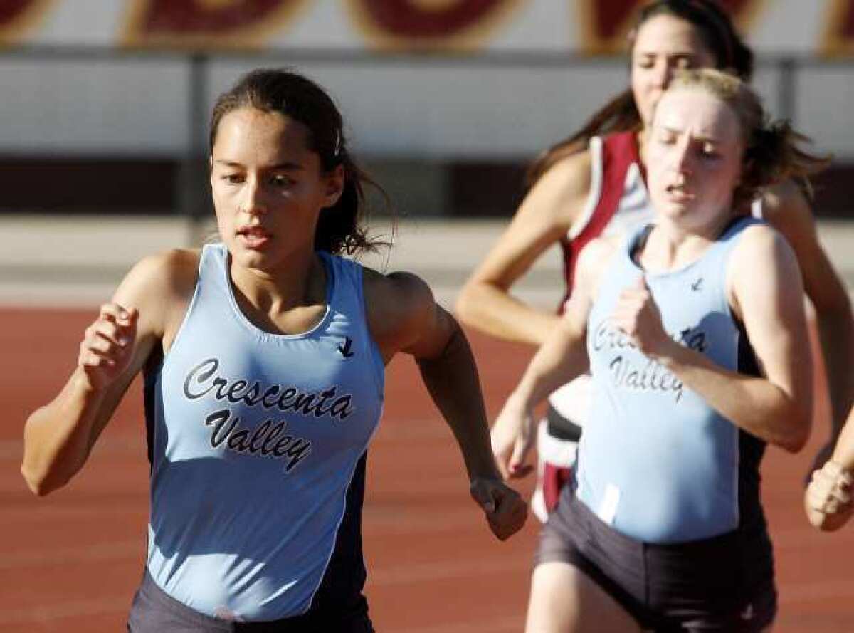 Crescenta Valley High's Megan Melnyk, left, was the only Falcons track and field competitor to win more than one event at Arcadia.
