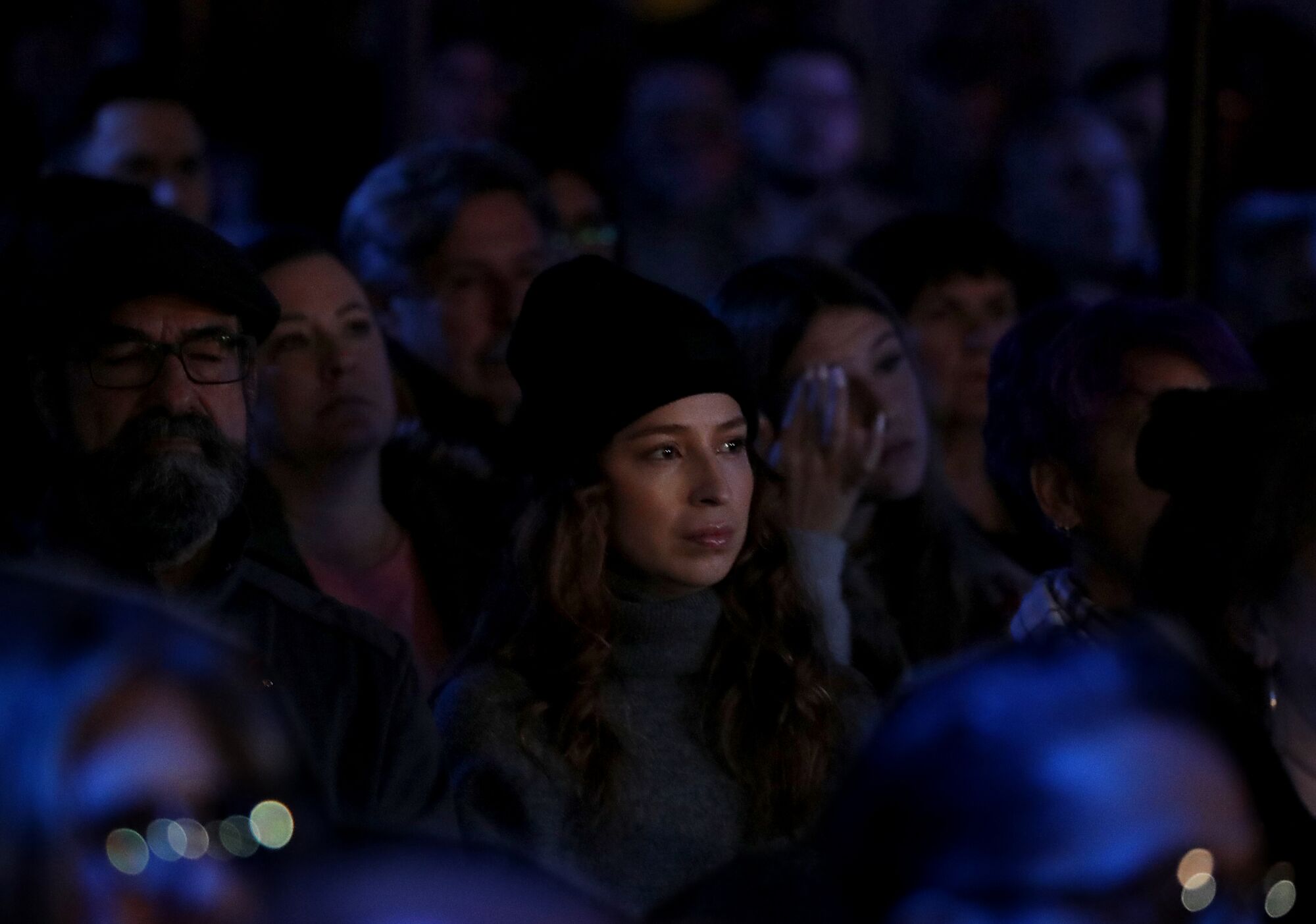 A crowd of people outdoors at night.